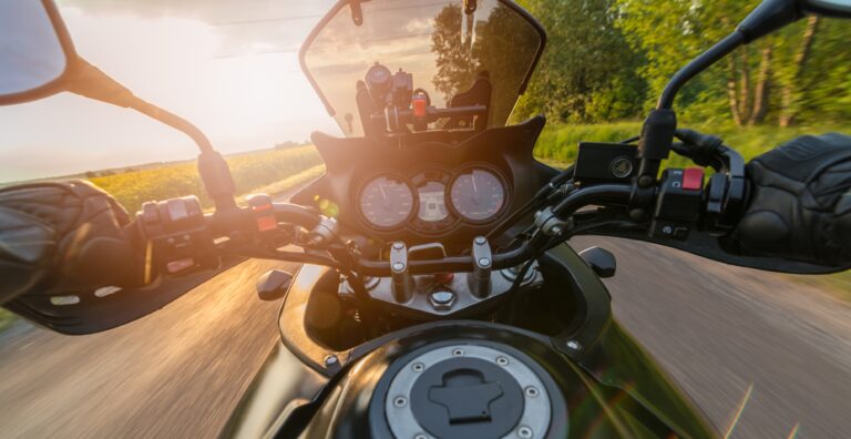 Man driving his motorcycle on asphalt country road